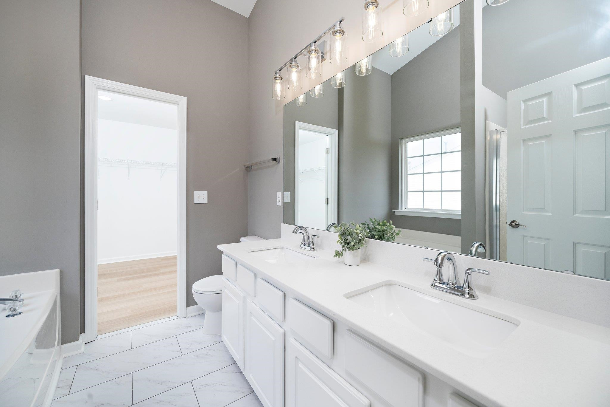4813 Alenja Lane Raleigh, NC 27616 - Photo 25 of 37 quartz countertops, tile floor, new shower door and fixtures Owners suite bath/spa