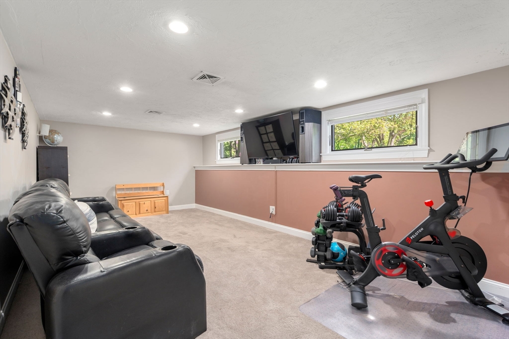 25 Fox Lane Concord, MA 01742 - Photo 11 of 24 a living room with furniture and a flat screen tv