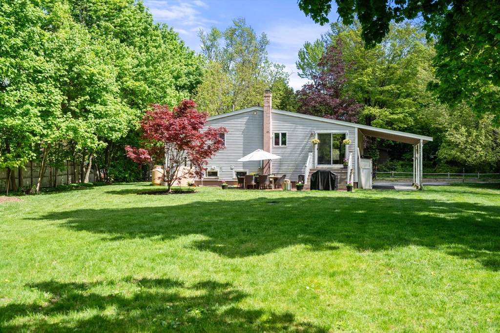 25 Fox Lane Concord, MA 01742 - Photo 15 of 24 a front view of house with a garden and trees