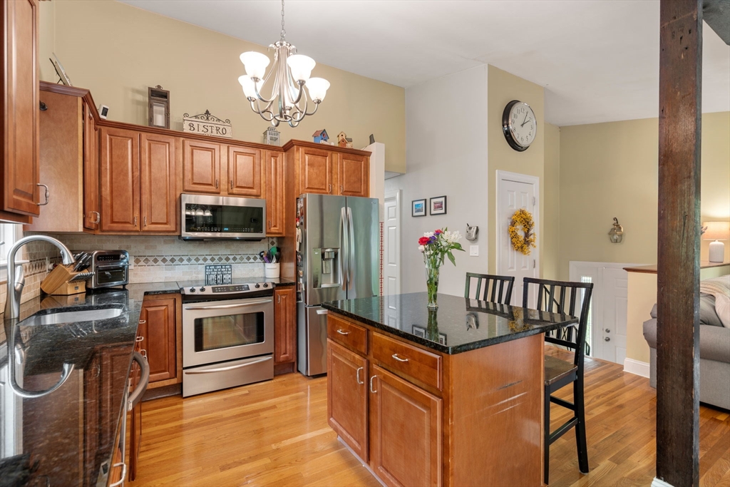 25 Fox Lane Concord, MA 01742 - Photo 3 of 24 a kitchen with stainless steel appliances granite countertop a refrigerator a stove top oven a sink and dishwasher