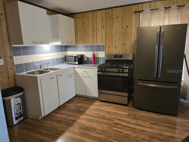 a kitchen with a refrigerator sink and stove