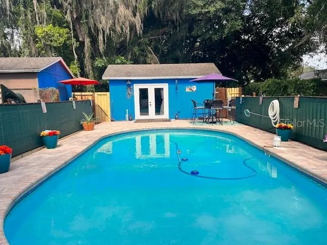 a front view of a house with swimming pool having outdoor seating