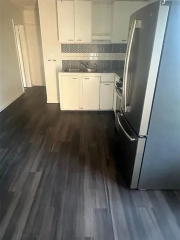 a view of a kitchen from a hallway