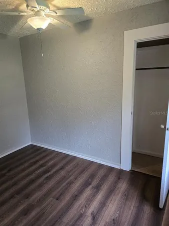 a view of a small space with wooden floor and staircase