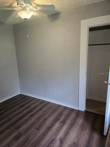 a view of a small space with wooden floor and staircase