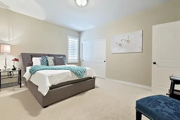 a bedroom with a bed and a table in it