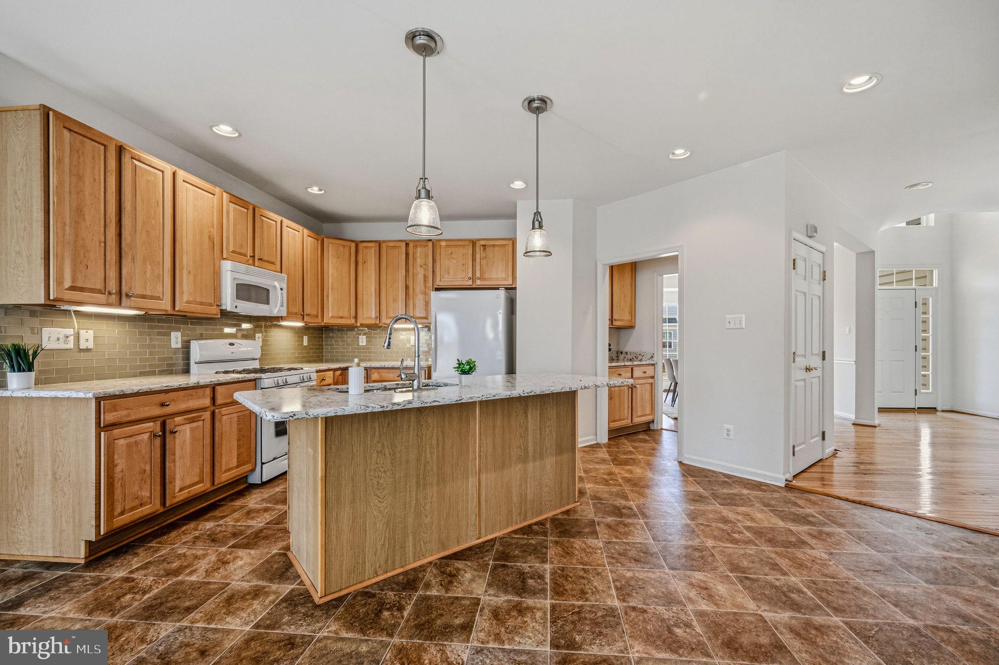 325 Pierce Run Newark, DE 19702 - Photo 10 of 42 a kitchen with stainless steel appliances granite countertop a refrigerator a sink dishwasher a stove and white cabinets with wooden floor