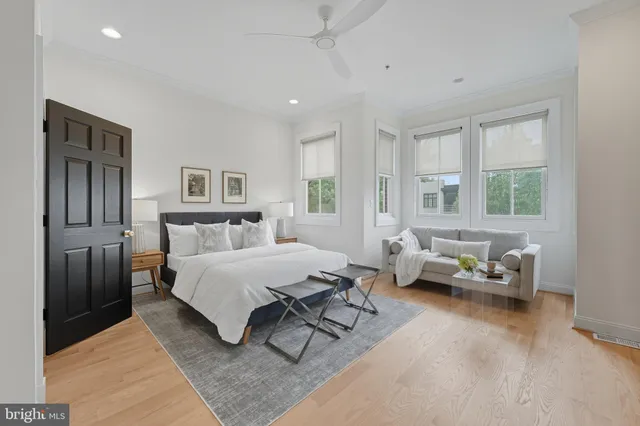 a spacious bedroom with a bed couch and a window