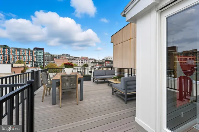 a view of a rooftop deck and patio