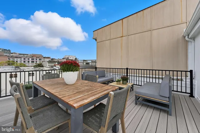 a view of a balcony with wooden floor and fence