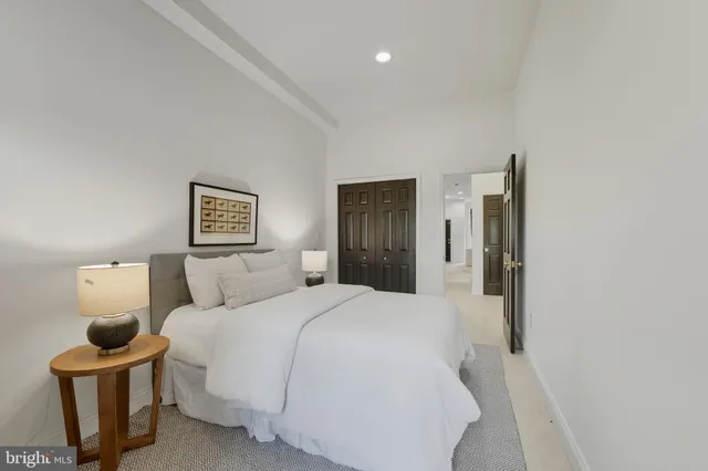 a bedroom with a bed and a lamp