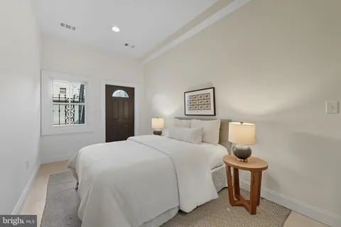 a bedroom with a bed and a night stand