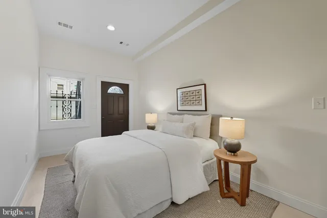 a bedroom with a bed and a night stand