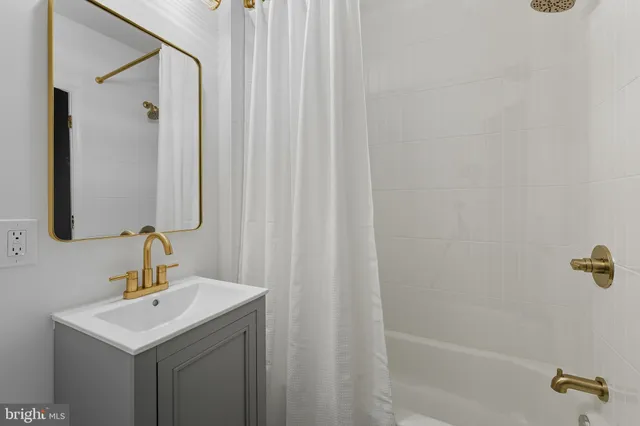 a bathroom with a sink a mirror and shower
