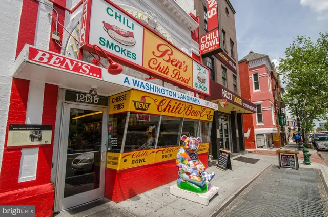 a view of a patio with table and chairs under an umbrella