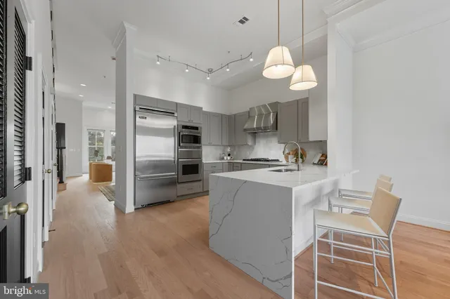 a living room with furniture and a large mirror