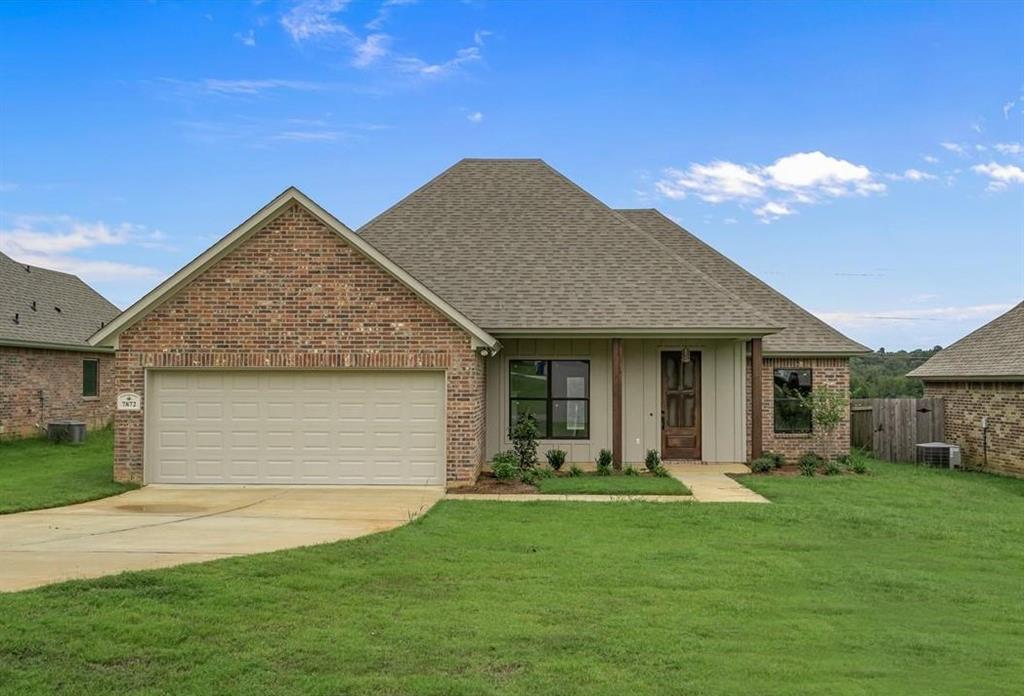 7872 Wasson Road Blanchard, LA 71107 - Photo 1 of 1 Single-story residence featuring a brick and vertical siding exterior
