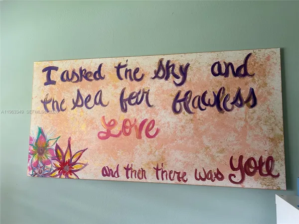 a street sign that has a bunch of graffiti on the wall