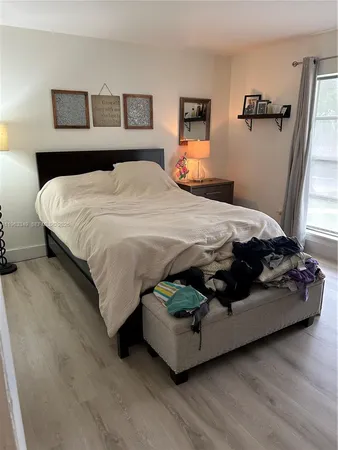 a bedroom with a bed and a night stand