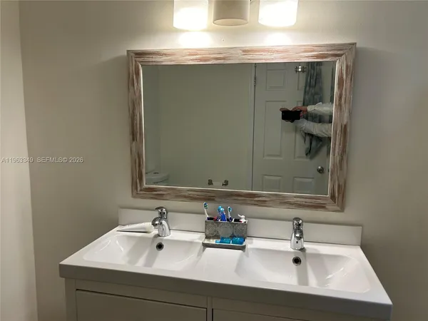 a bathroom with a sink and a mirror