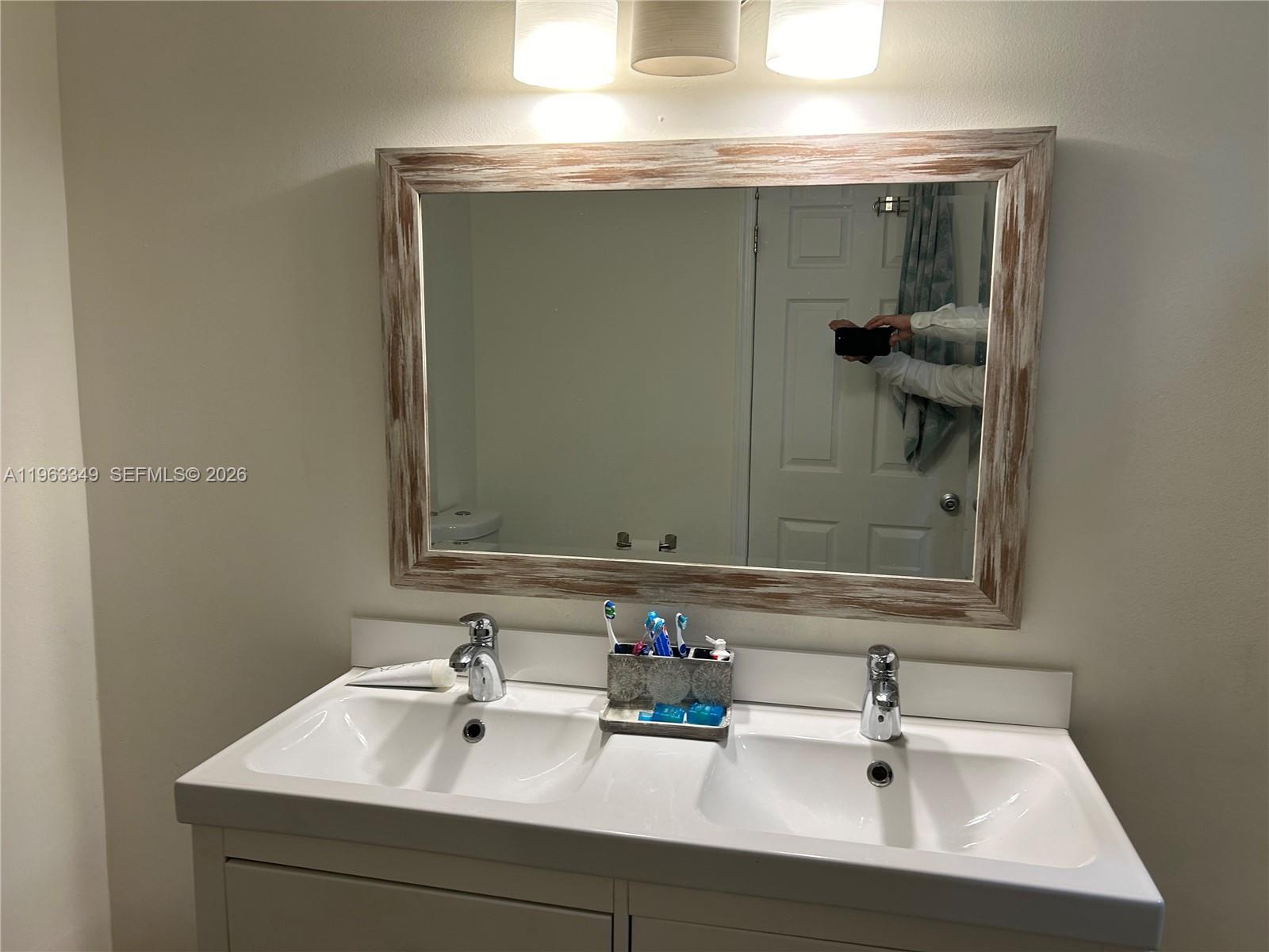 6619 Southwest 116th Place, Unit B7 Miami, FL 33173 - Photo 14 of 27 a bathroom with a sink and a mirror