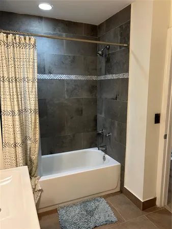a bathroom with a bathtub and a shower