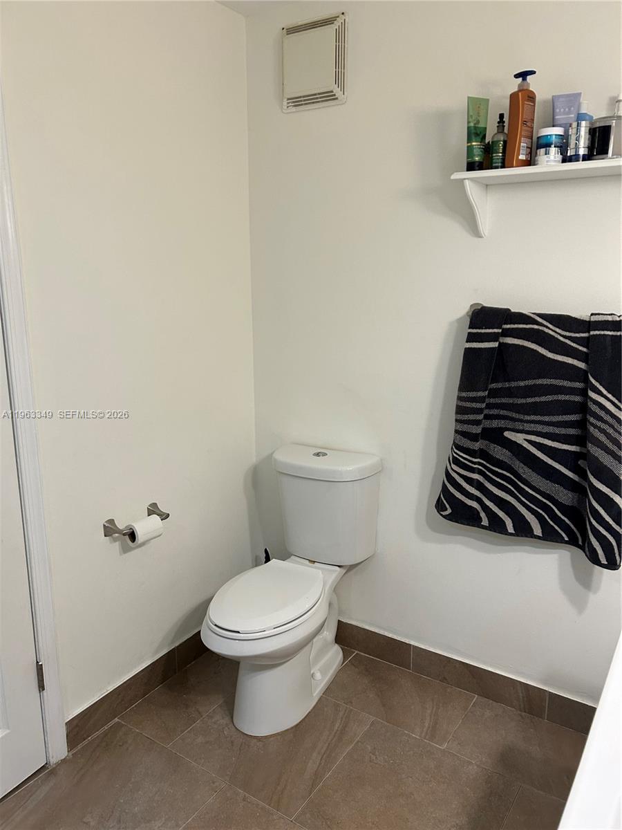 6619 Southwest 116th Place, Unit B7 Miami, FL 33173 - Photo 16 of 27 a bathroom with a toilet and a sink