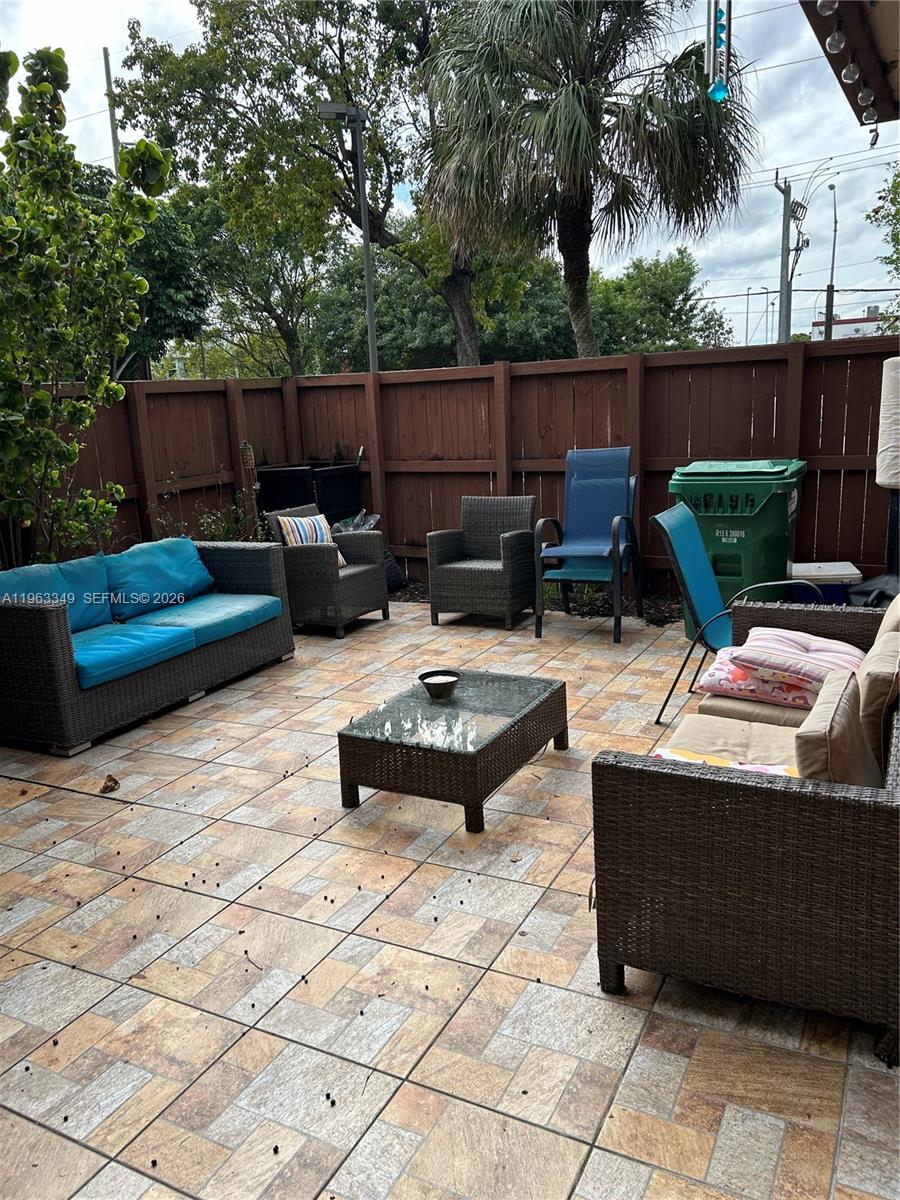 6619 Southwest 116th Place, Unit B7 Miami, FL 33173 - Photo 20 of 27 a backyard of a house with barbeque oven table and chairs