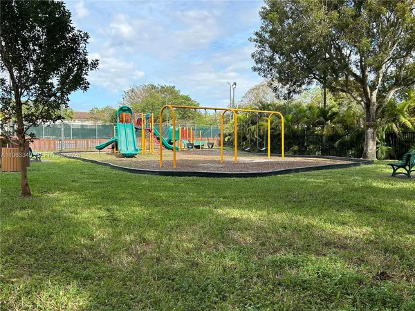 a view of a park with swings and slides