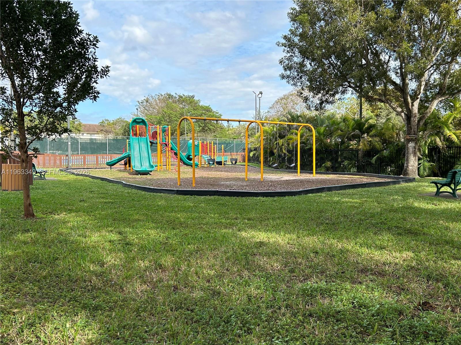 6619 Southwest 116th Place, Unit B7 Miami, FL 33173 - Photo 26 of 27 a view of a park with swings and slides