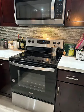 a stove top oven sitting inside of a kitchen