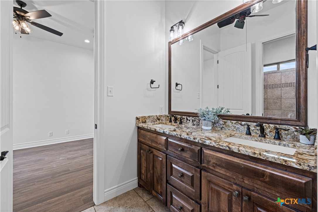 11023 Bigham Road Troy, TX 76579 - Photo 33 of 42 a bathroom with a granite countertop sink and a mirror