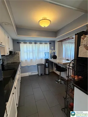 a kitchen with a table and chairs in it