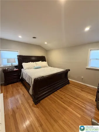 a bedroom with a bed and a night stand