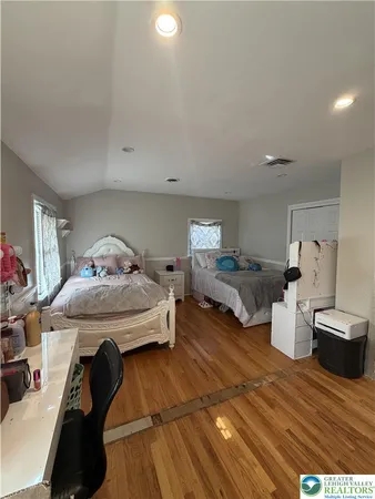 a bedroom with furniture and a wooden floor