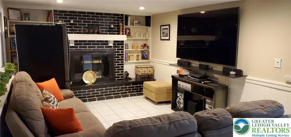 a living room with furniture a rug and a fireplace