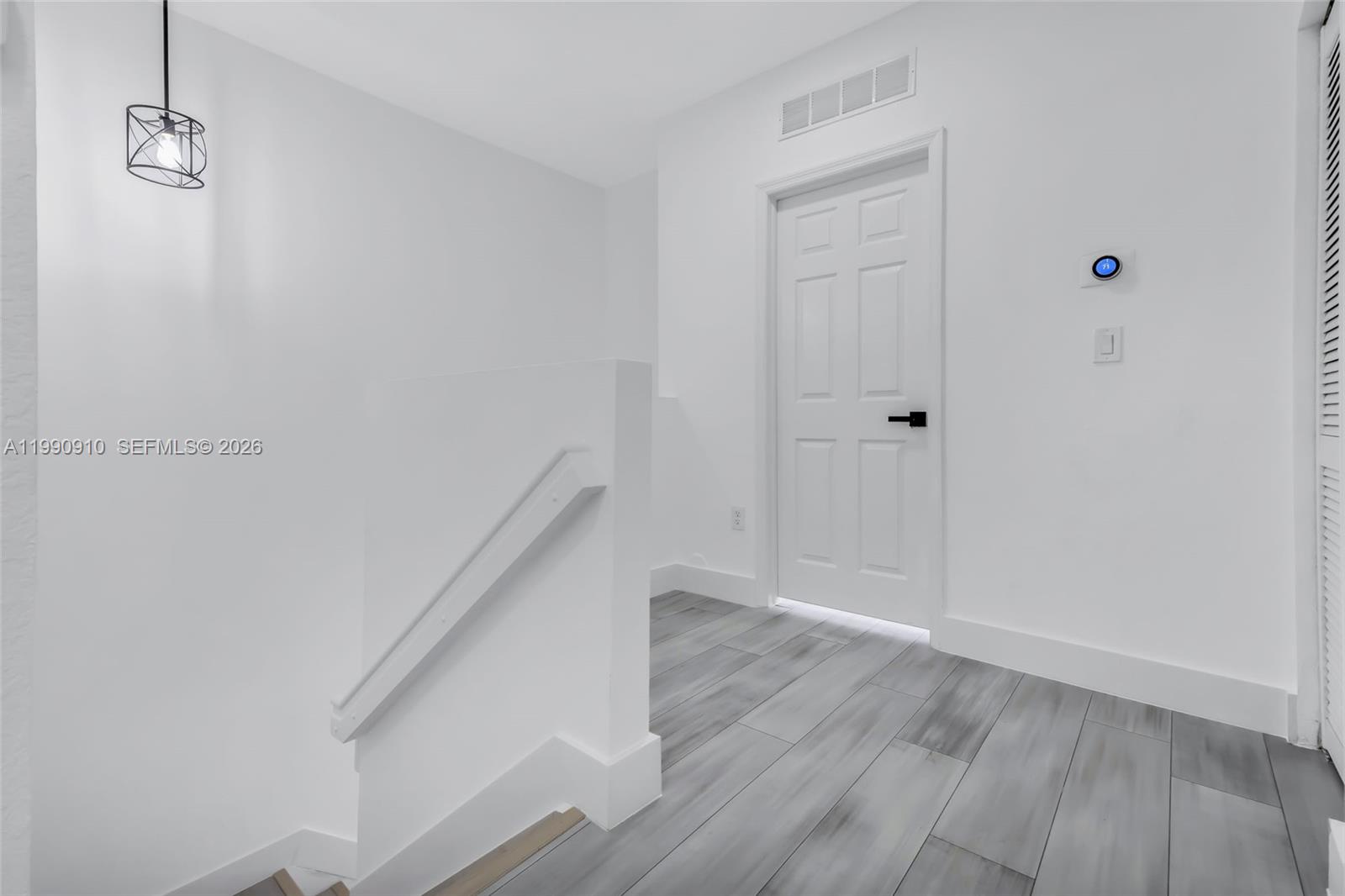 4977 Southwest 135th Way Miramar, FL 33027 - Photo 12 of 28 a view of a hallway with wooden floor and staircase