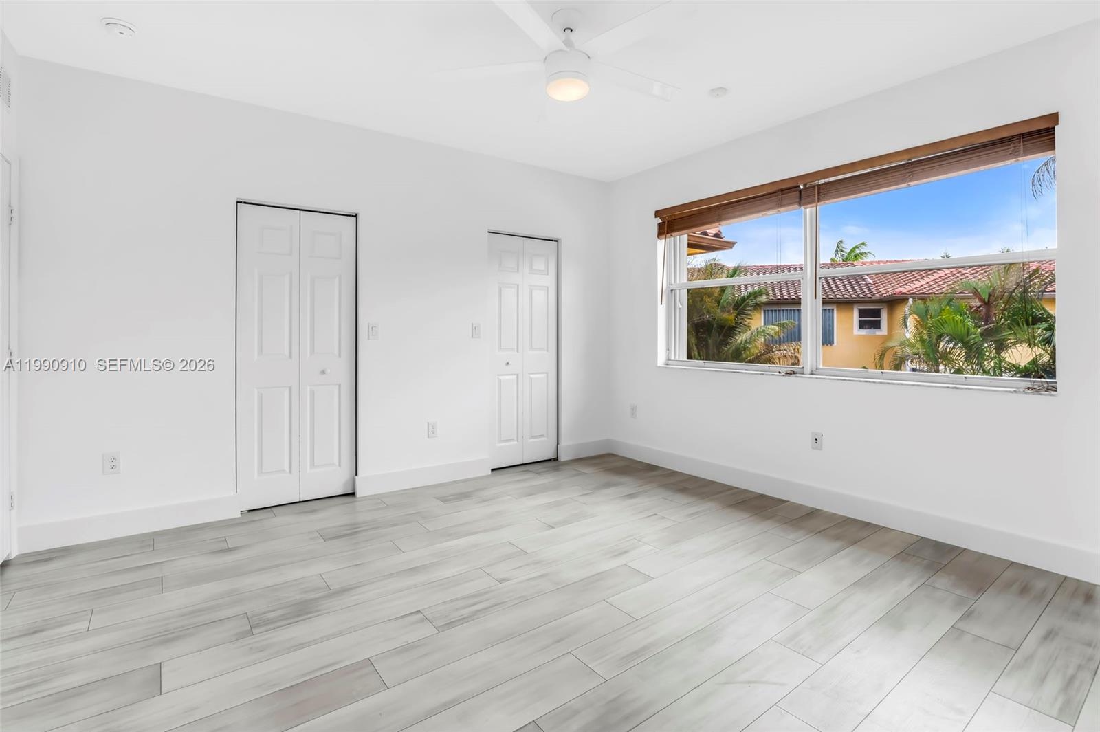 4977 Southwest 135th Way Miramar, FL 33027 - Photo 14 of 28 an empty room with wooden floor and windows