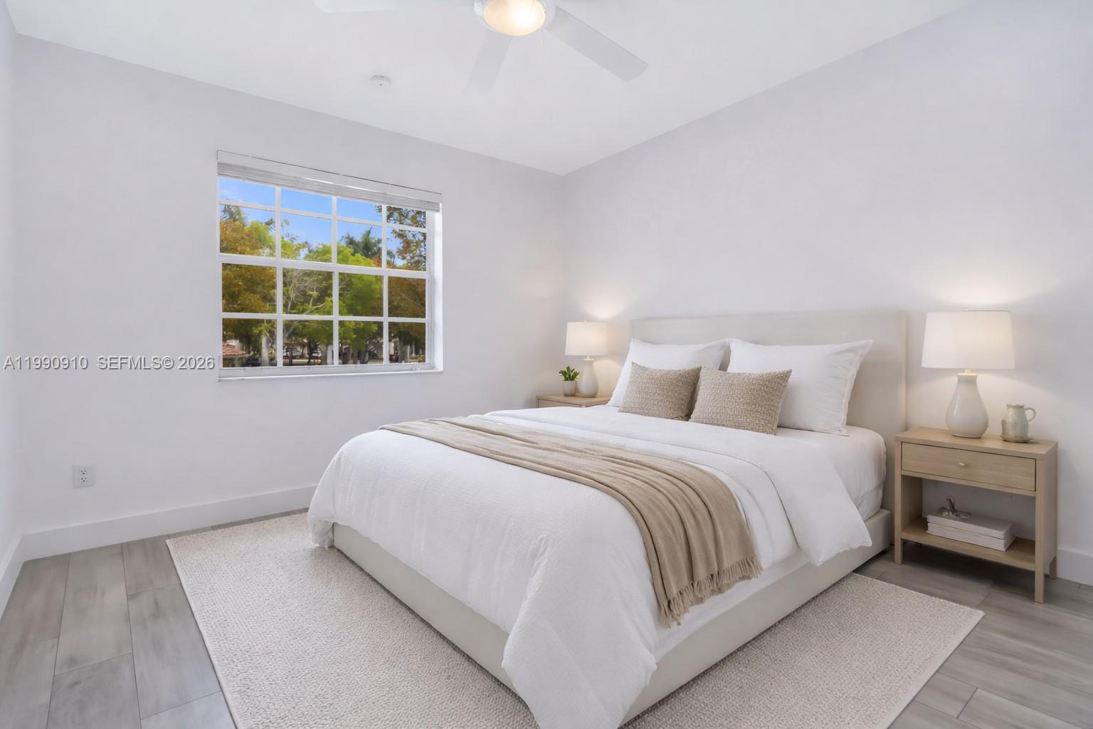 4977 Southwest 135th Way Miramar, FL 33027 - Photo 16 of 28 a bedroom with a bed and next to a window