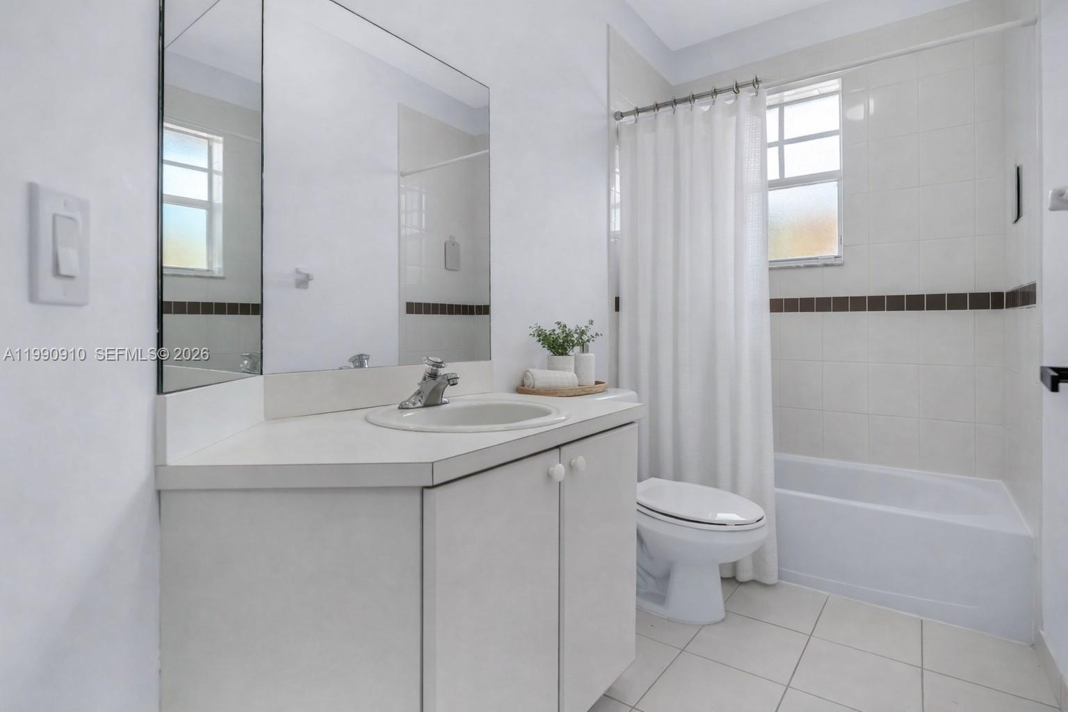 4977 Southwest 135th Way Miramar, FL 33027 - Photo 18 of 28 a bathroom with a sink toilet and shower