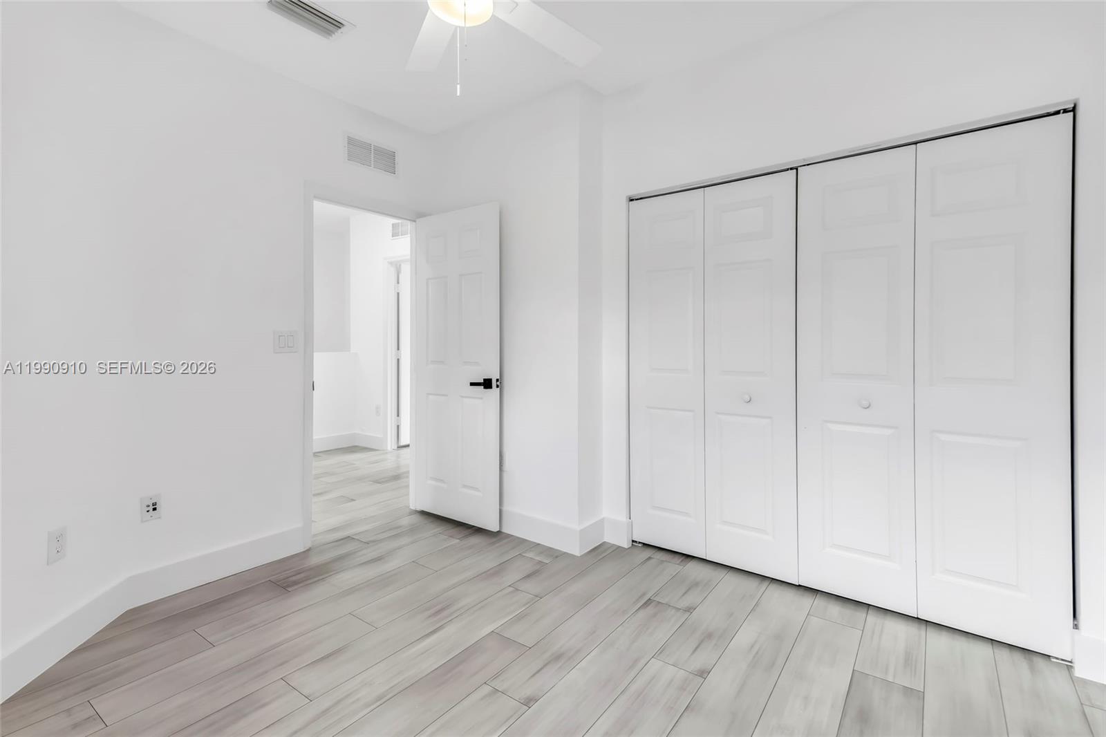 4977 Southwest 135th Way Miramar, FL 33027 - Photo 20 of 28 a view of an empty room with wooden floor