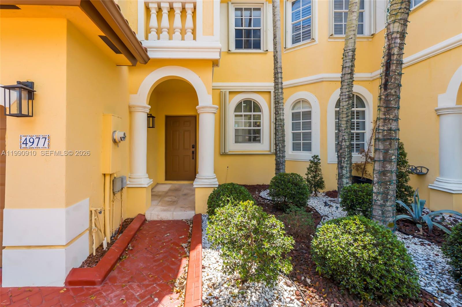 4977 Southwest 135th Way Miramar, FL 33027 - Photo 2 of 28 a view of a building with many windows