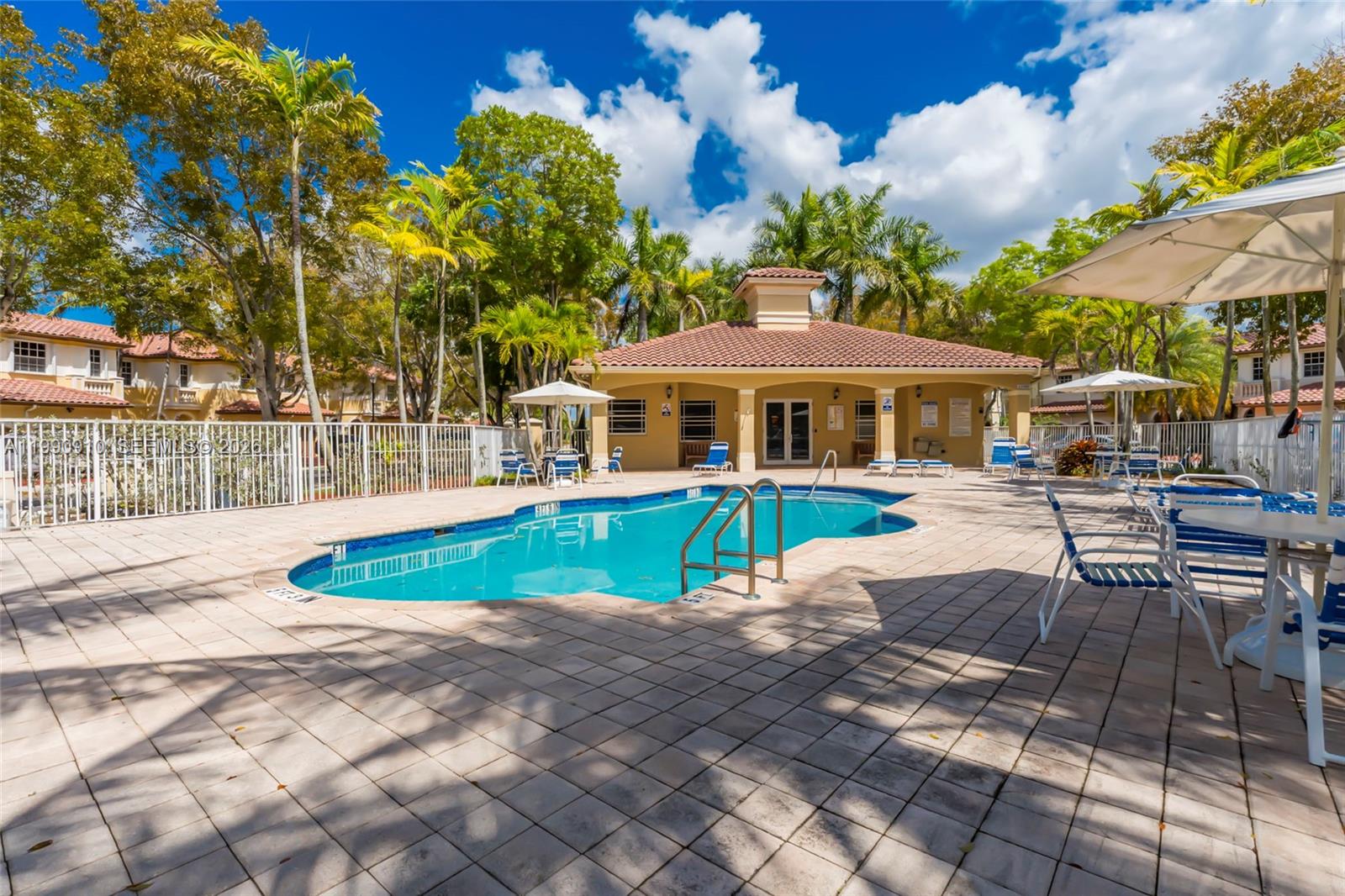 4977 Southwest 135th Way Miramar, FL 33027 - Photo 22 of 28 a view of a patio with a table and chairs under an umbrella