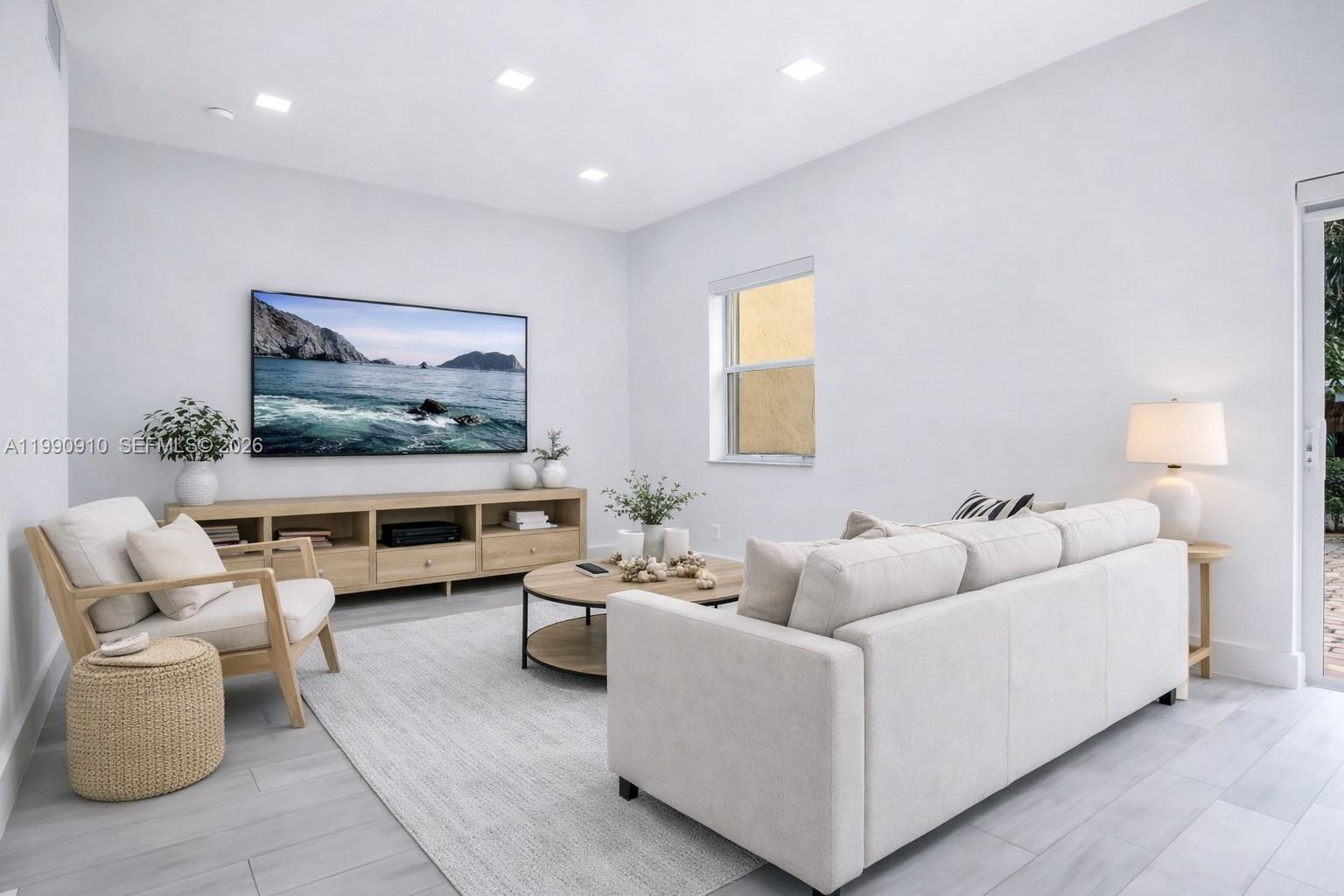 4977 Southwest 135th Way Miramar, FL 33027 - Photo 7 of 28 a living room with furniture and a flat screen tv