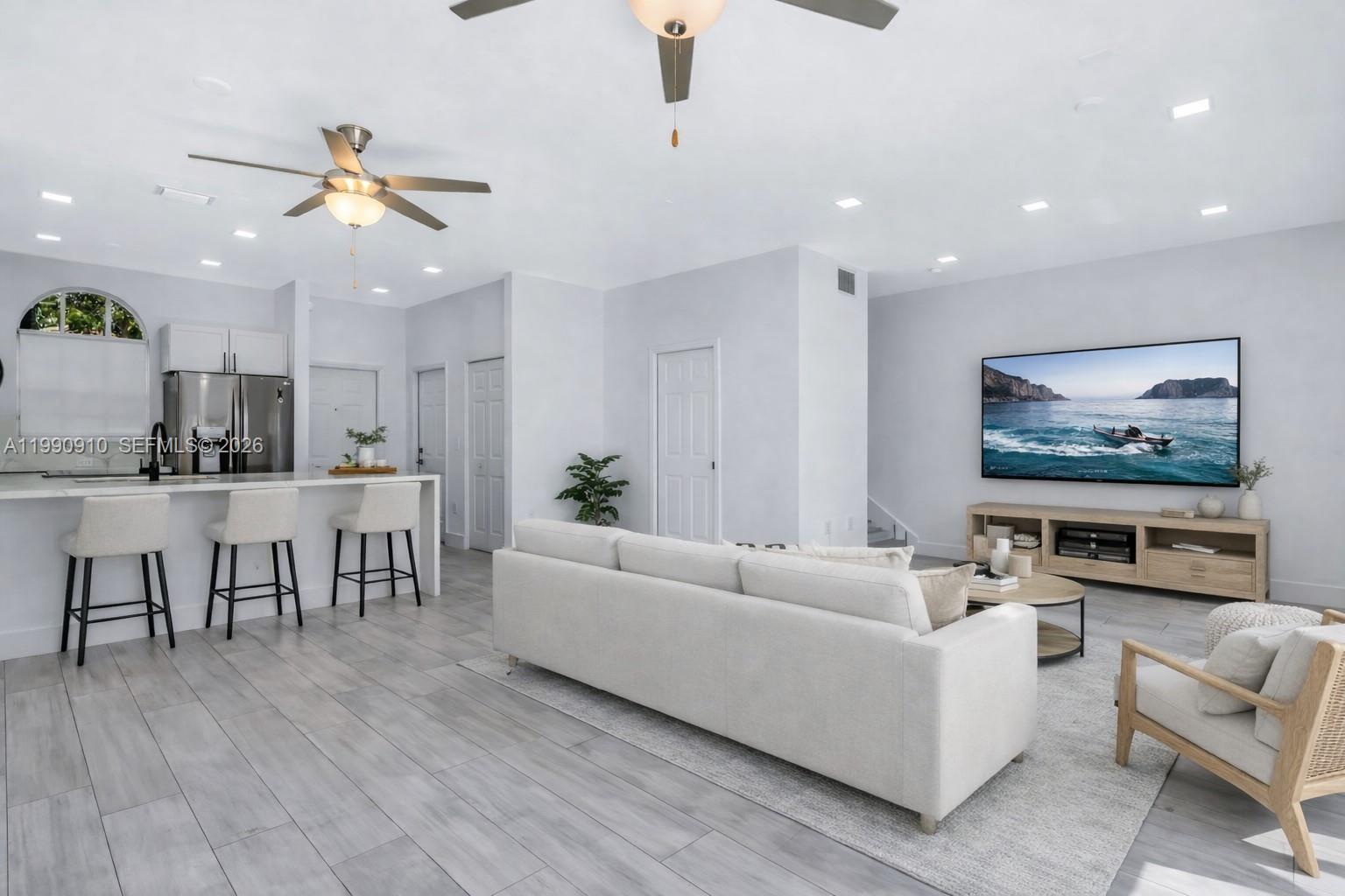 4977 Southwest 135th Way Miramar, FL 33027 - Photo 8 of 28 a living room with furniture and a flat screen tv