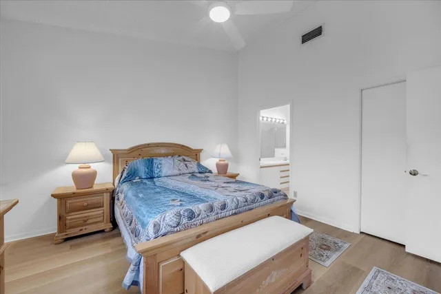 a bedroom with a bed and a lamp on table