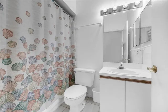 a bathroom with a sink toilet and a mirror