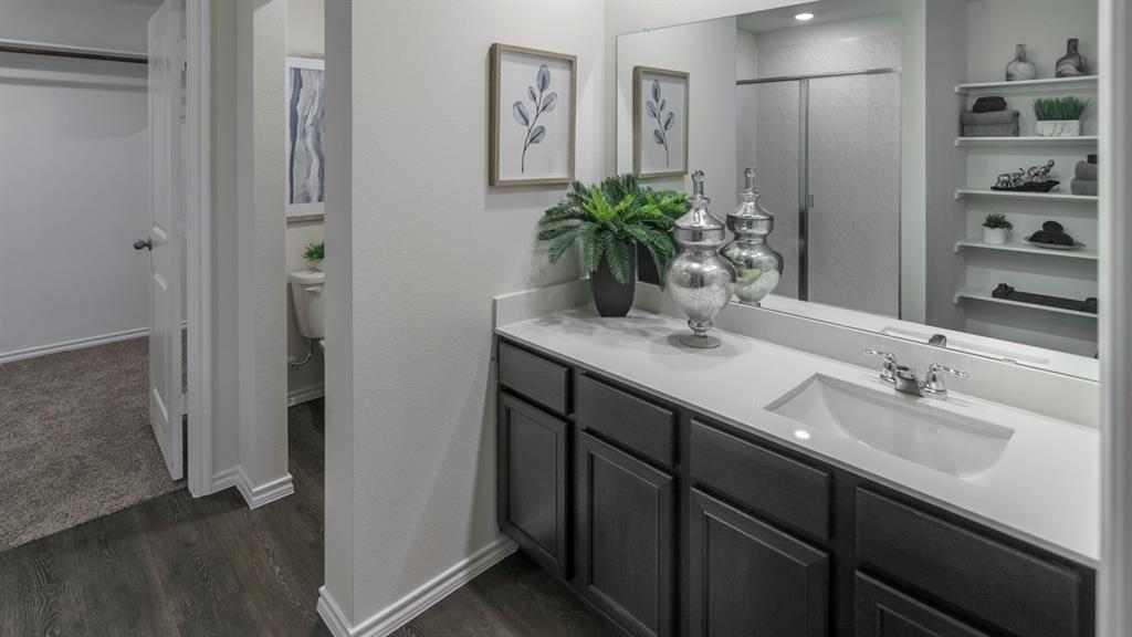 3100 Charleston Drive Ennis, TX 75119 - Photo 14 of 23 Bathroom vanity featuring a single integrated sink, chrome faucet, and quartz countertop