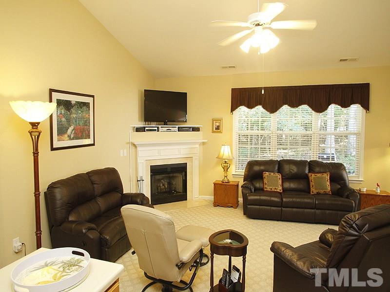 10307 Dapping Drive Raleigh, NC 27614 - Photo 3 of 16 a living room with furniture fireplace and a flat screen tv