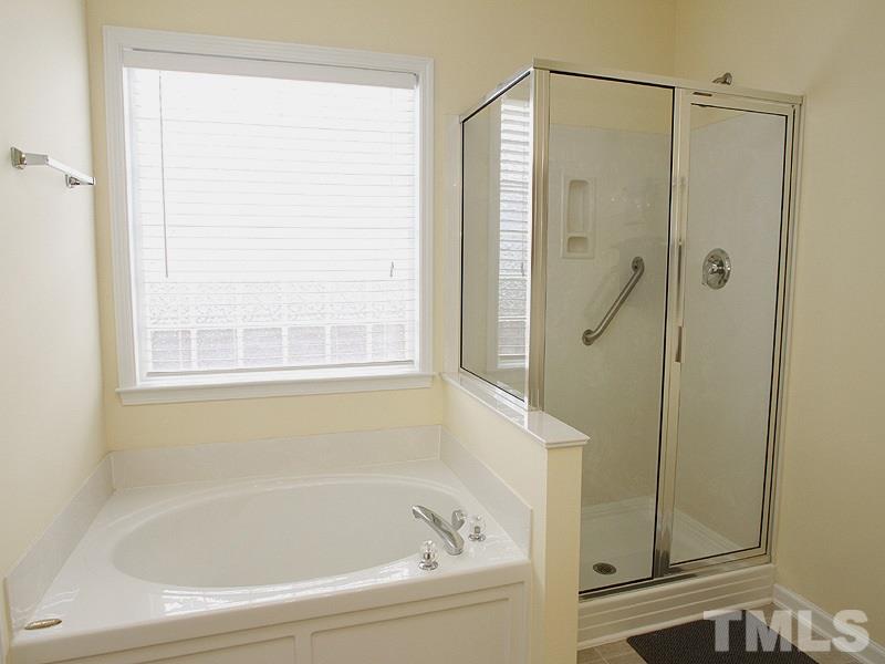 10307 Dapping Drive Raleigh, NC 27614 - Photo 8 of 16 a white bath tub sitting next to a shower